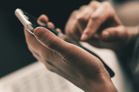 A picture of a women's hand holding a phone.